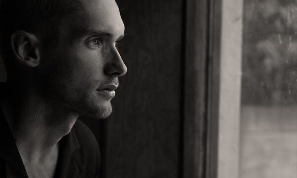 Man looking through window