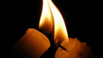 A candle being lit by another's flame