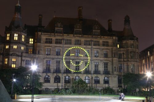 A happy face projected onto Sheffield Town Hall