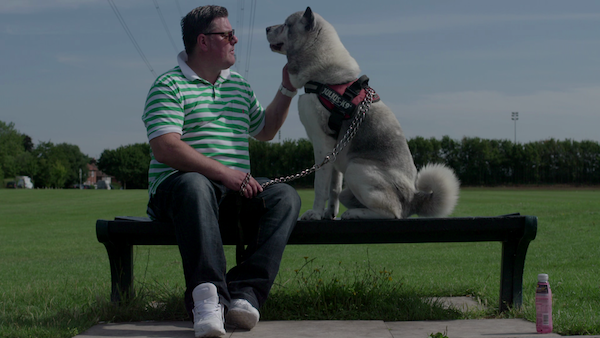 Bench with a man and dog sitting on it