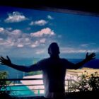 young man standing on a balcony on holiday