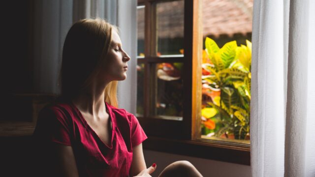 woman sat by a window