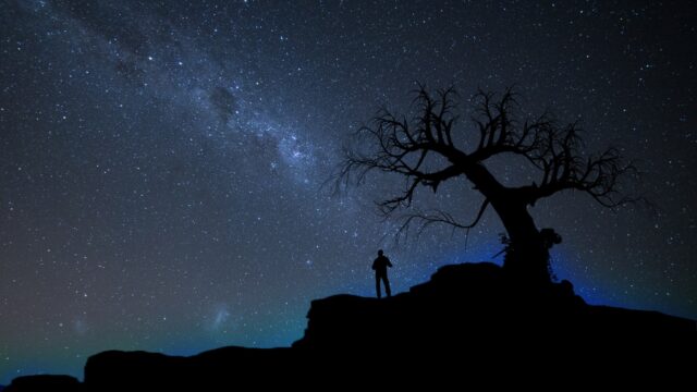 Silhouette against a dark starry sky