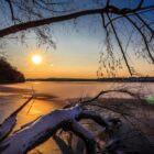 low sun shining over a frozen lake