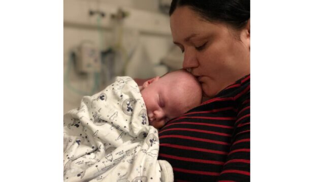 baby asleep on mother