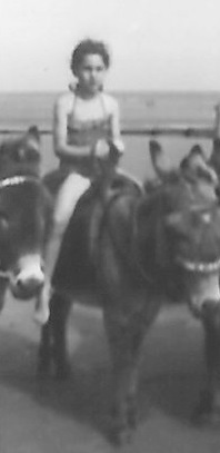 Trish riding a donkey as a child