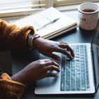 woman typing on laptop