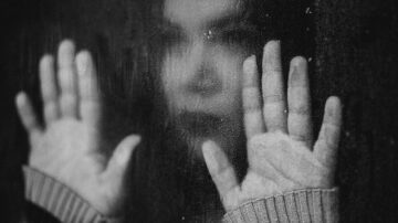 girl trapped behind glass
