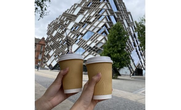 2 coffee cups held up