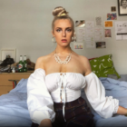 Abs sitting on her bed