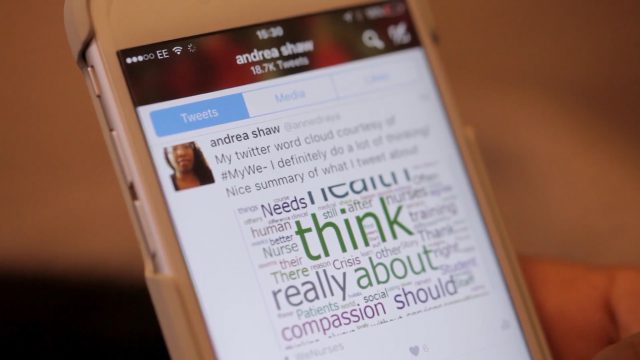 Andrea Shaw's Twitter account showing on a phone screen