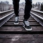 feet walking along a rail track