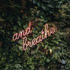 lit up text saying 'and breathe'