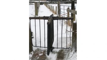 Revolving gate on a snowy path